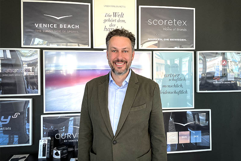 CFO/COO Marco Hoffmeyer in light blue shirt and olive green jacket, smiling.